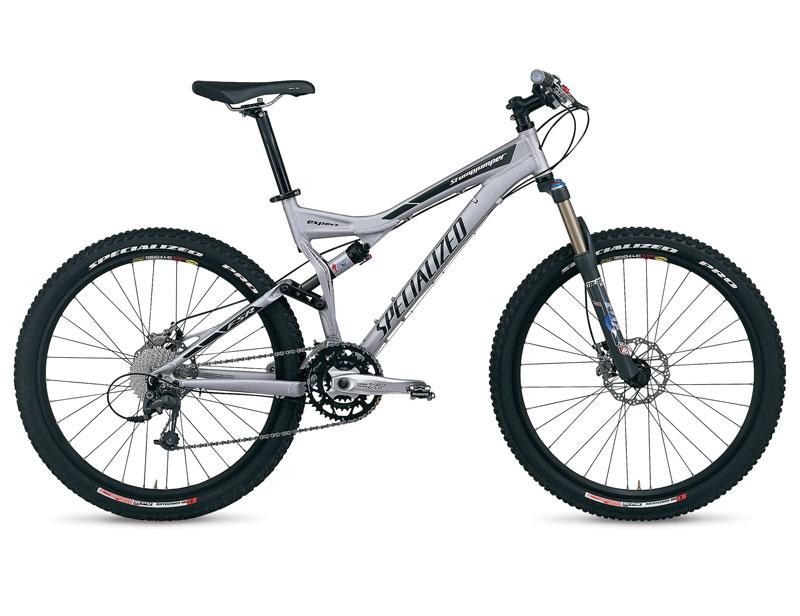 Specialized Stumpjumper FSR Expert: Alt tag: A silver Specialized mountain bike with dual suspension, featuring knobby tires and a modern design, positioned against a plain background.