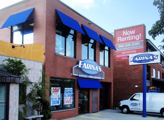 Image of a brick building featuring the storefront of "Farina