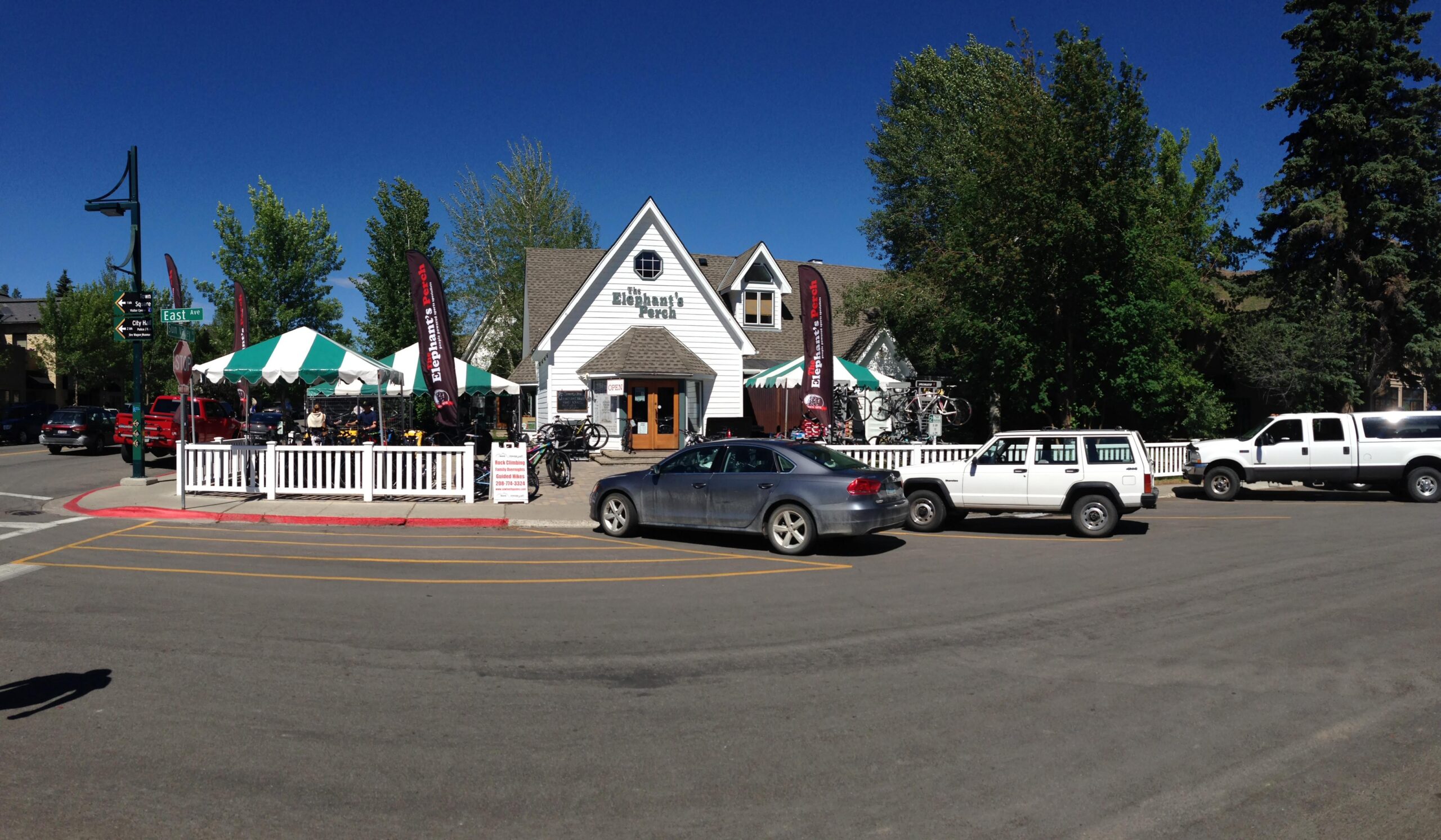 A bright sunny day outside a bike shop named "The Elephant