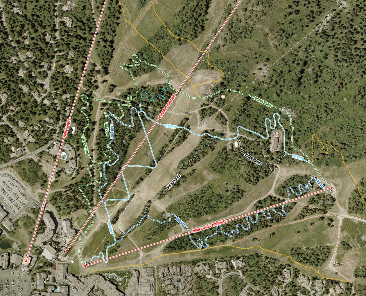 Alt text: A detailed map of a mountainous area showing various trails and paths, labeled with names like "Lucky Charm," "Bandit," and "Quick Drain." The map also indicates surrounding infrastructure, including nearby buildings and parking areas, with different colored lines representing different types of trails. Jackson Hole Bike Park mountain bike trail.