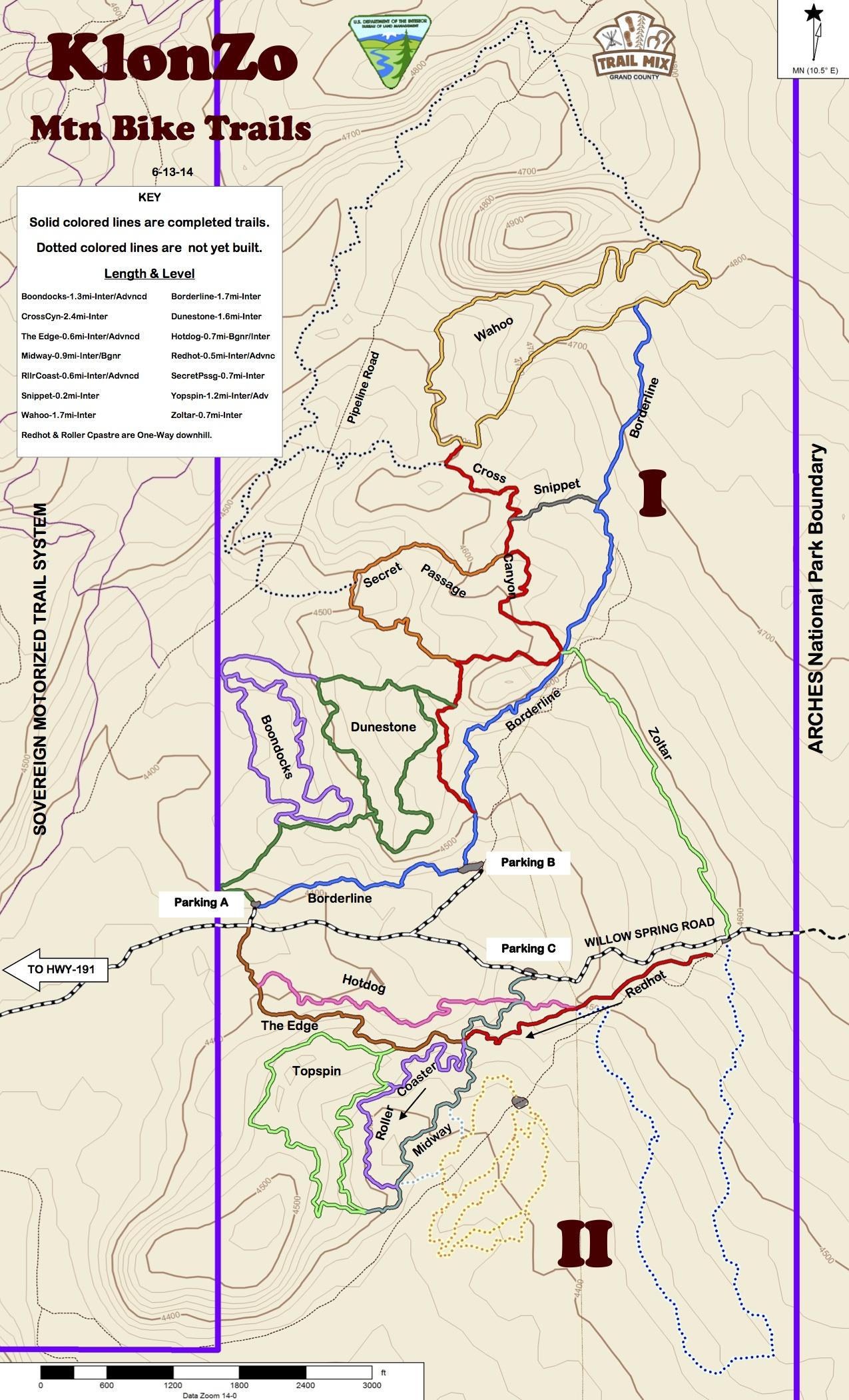 A detailed map of KlonZo Mountain Bike Trails, showcasing various completed and planned biking routes. The map features solid colored lines representing completed trails and dotted lines indicating trails that are not yet built. Key components include trail names, difficulty levels, parking areas, and the boundary of Arches National Park. Elevation contours are also illustrated, providing a clear overview of the terrain. Klonzo Area mountain bike trail.