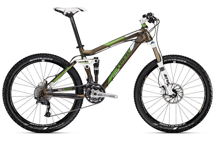 Trek Fuel EX 8: A high-performance mountain bike featuring a sleek design with a brown and green color scheme. The bike is equipped with front and rear suspension, disc brakes, and knobby tires designed for rugged terrain, showcasing its suitability for off-road cycling adventures.