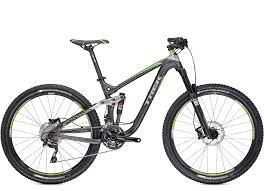 Trek Remedy 7: A modern mountain bike with a sleek black and green frame, featuring front suspension, disc brakes, and thick tires designed for off-road riding.