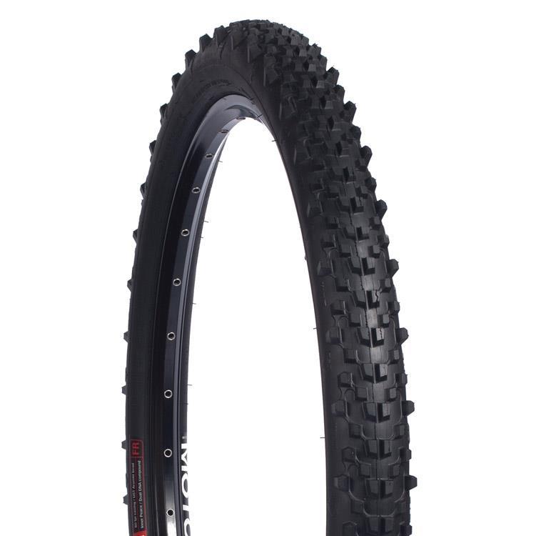 Wtb Moto 2.3 AM TCS: A close-up image of a mountain bike tire featuring a knobby tread pattern designed for off-road traction. The tire is black with a shiny rim and visible spoke holes, showcasing its rugged design for enhanced grip on various terrains.