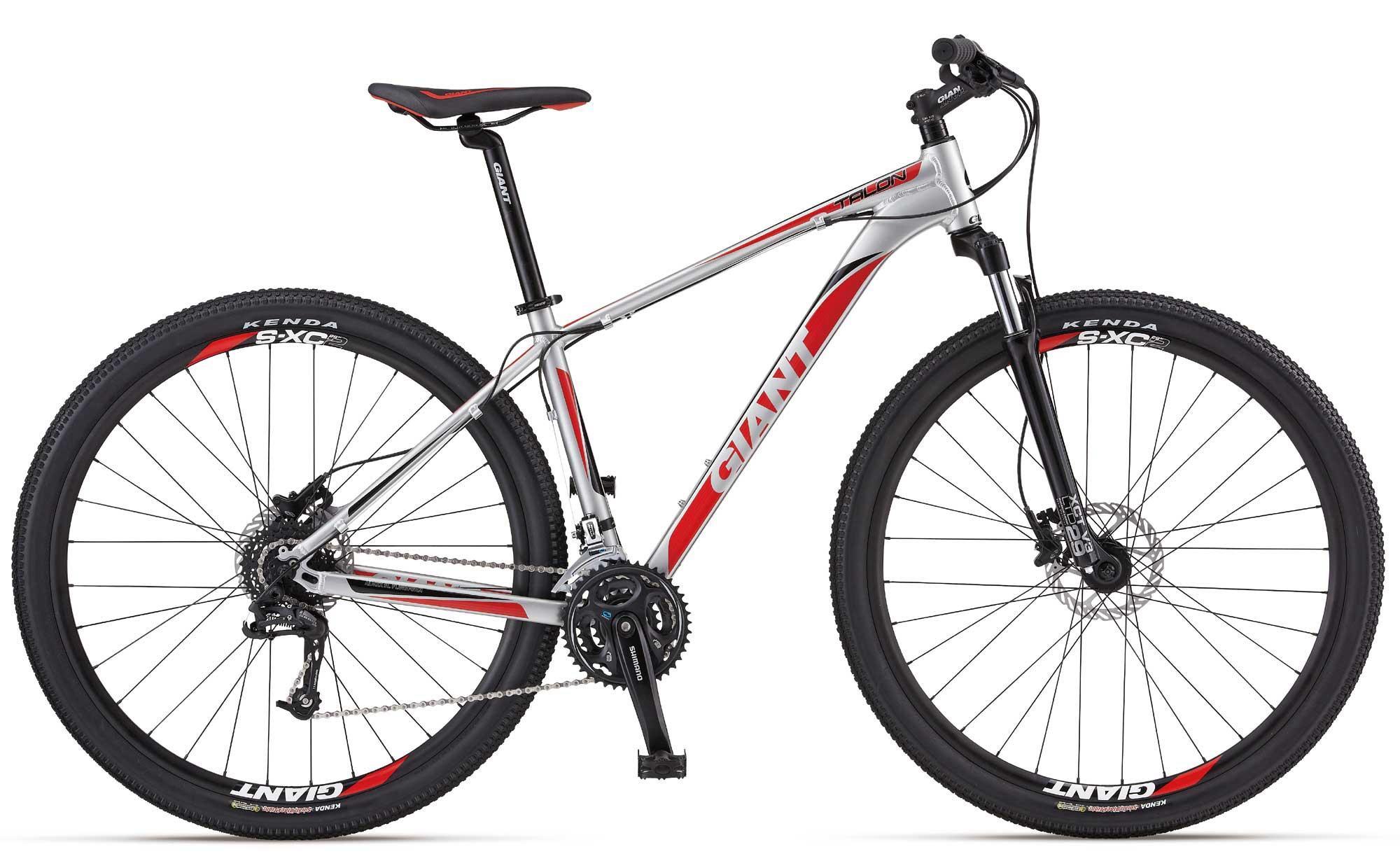 Giant Talon 29er 1: A silver and red mountain bike featuring a lightweight frame, thick tires, and multiple gears. The bike has "Giant" branding on the frame, seat, and tires, and is designed for off-road riding.