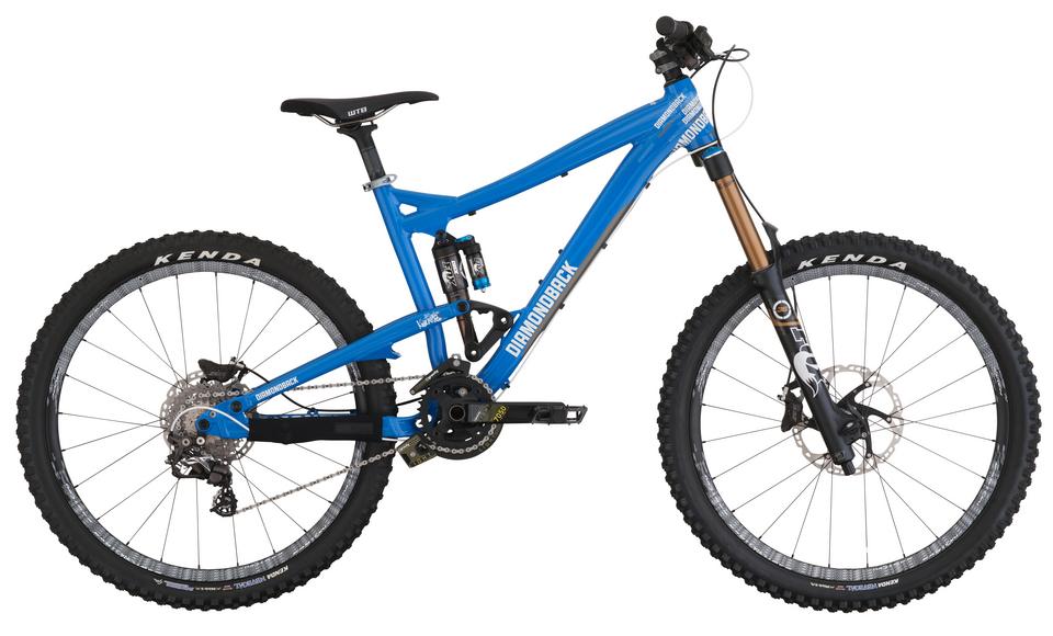 Diamondback Scapegoat: Blue mountain bike with a dual suspension design, featuring Kenda tires, a lightweight frame, and a prominent brand logo on the side. The bike includes disc brakes and a high-performance fork, suitable for off-road riding.
