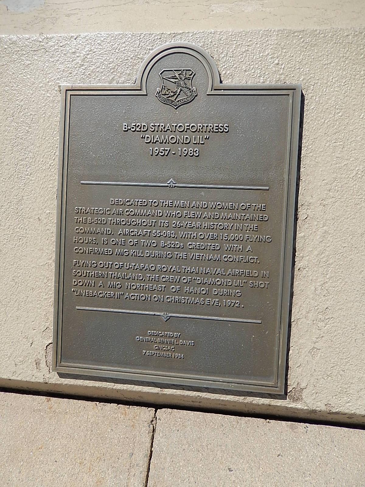 Plaque commemorating the B-52D Stratofortress "Diamond Lil," dedicated to the personnel of Strategic Air Command from 1957 to 1983. The plaque honors aircraft 55-083, which completed over 15,000 flying hours and is noted for its role in the Vietnam War, including the first confirmed MiG kill. The dedication was made by General Benjamin L. Davis on September 7, 1984. Falcon Trail mountain bike trail.