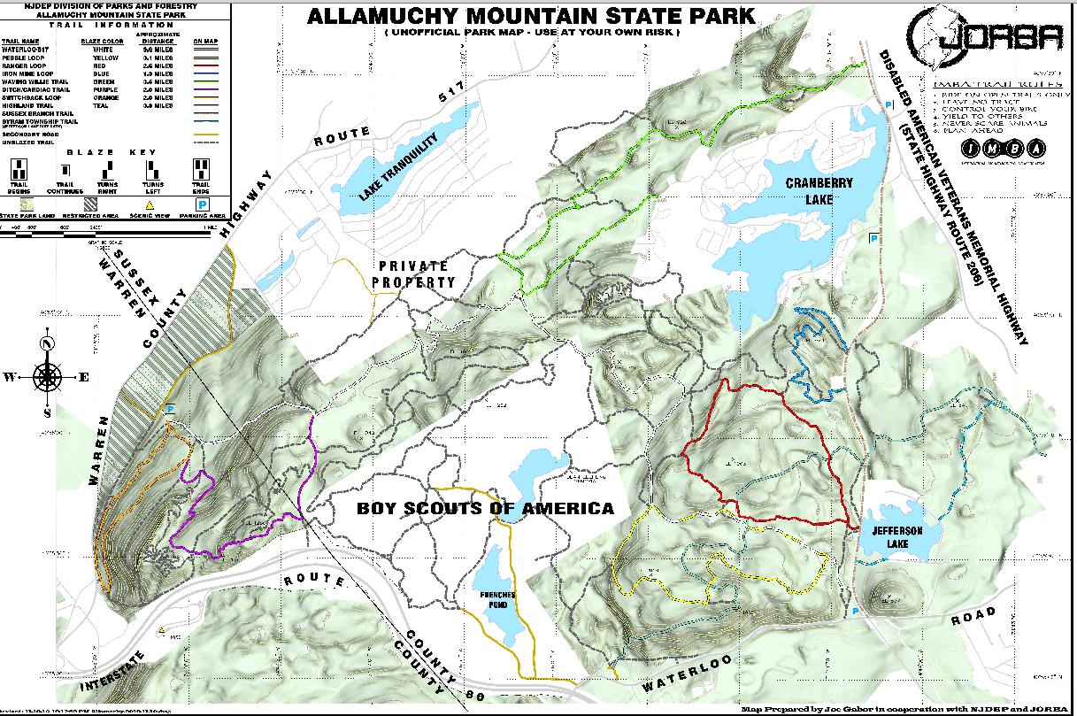 Map of Allamuchy Mountain State Park, featuring various trails, lakes, and notable landmarks. The map includes a key with trail blazes, a compass orientation, and indicates areas of private property. Paths are marked in different colors, denoting difficulty levels and types, along with important information for park visitors. Allamuchy North-Deer Park-Stephens Connecter Ride mountain bike trail.