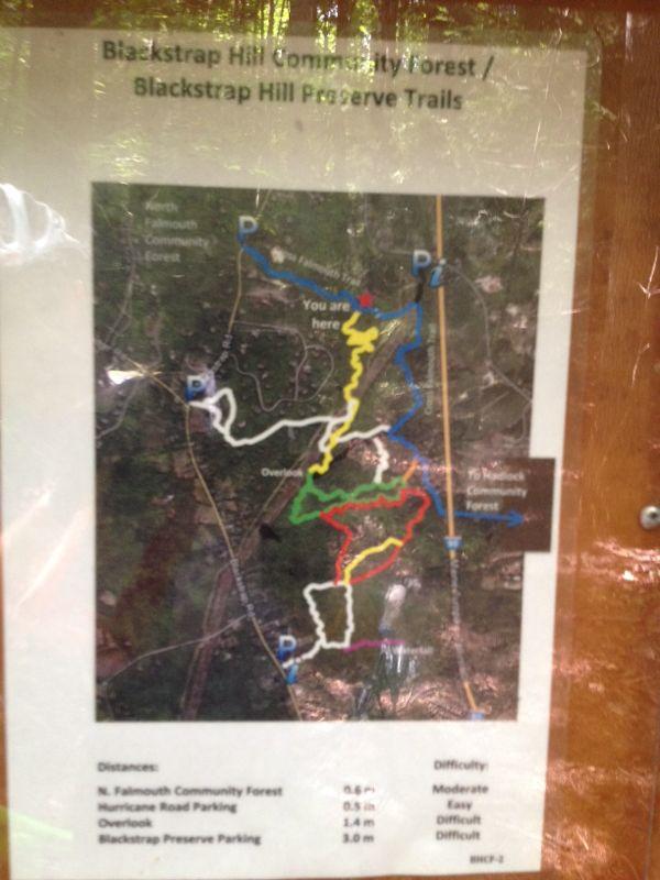 Map of Blackstrap Hill Community Forest and Preserve Trails, indicating various trail routes marked in different colors (yellow, white, blue, green, and red) and key locations including parking areas. The map also features distance and difficulty information for trails, with a highlighted "You are here" marker. Blackstrap Hill Preserve mountain bike trail.