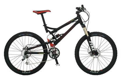 Mongoose Teocali Super: A black mountain bike with a red and silver accent, featuring thick tires, front suspension, and multiple gears. The bike is positioned upright against a neutral background.