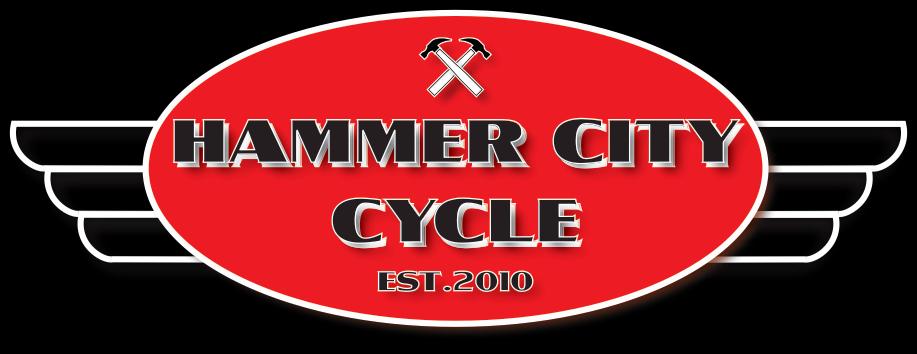 Red oval logo for "Hammer City Cycle," featuring the name in bold letters, crossed hammers above it, and the text "EST. 2010" at the bottom, all set against a black background with wing designs on either side.