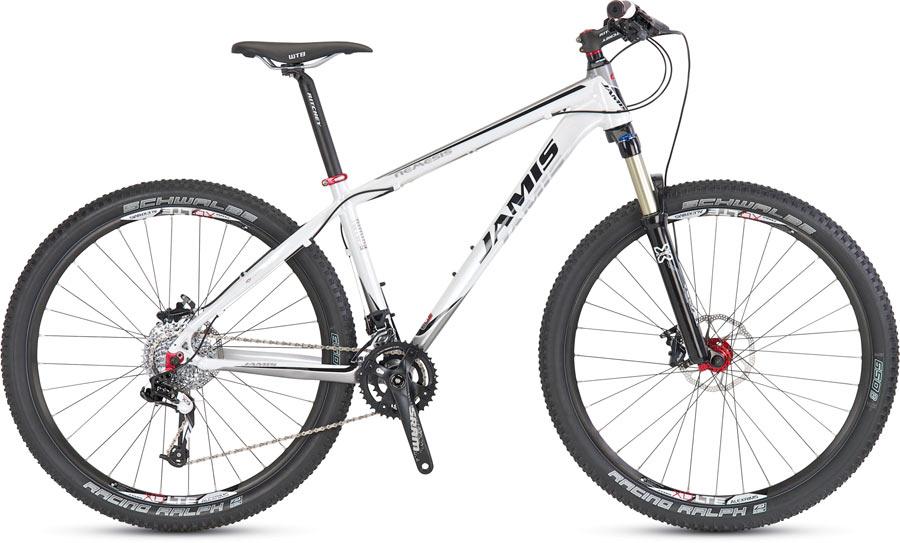Jamis Nemesis: A white mountain bike featuring a lightweight aluminum frame, front suspension, and wide tires suitable for off-road trails. The bike is equipped with a high-performance drivetrain and disc brakes for enhanced control and stopping power.