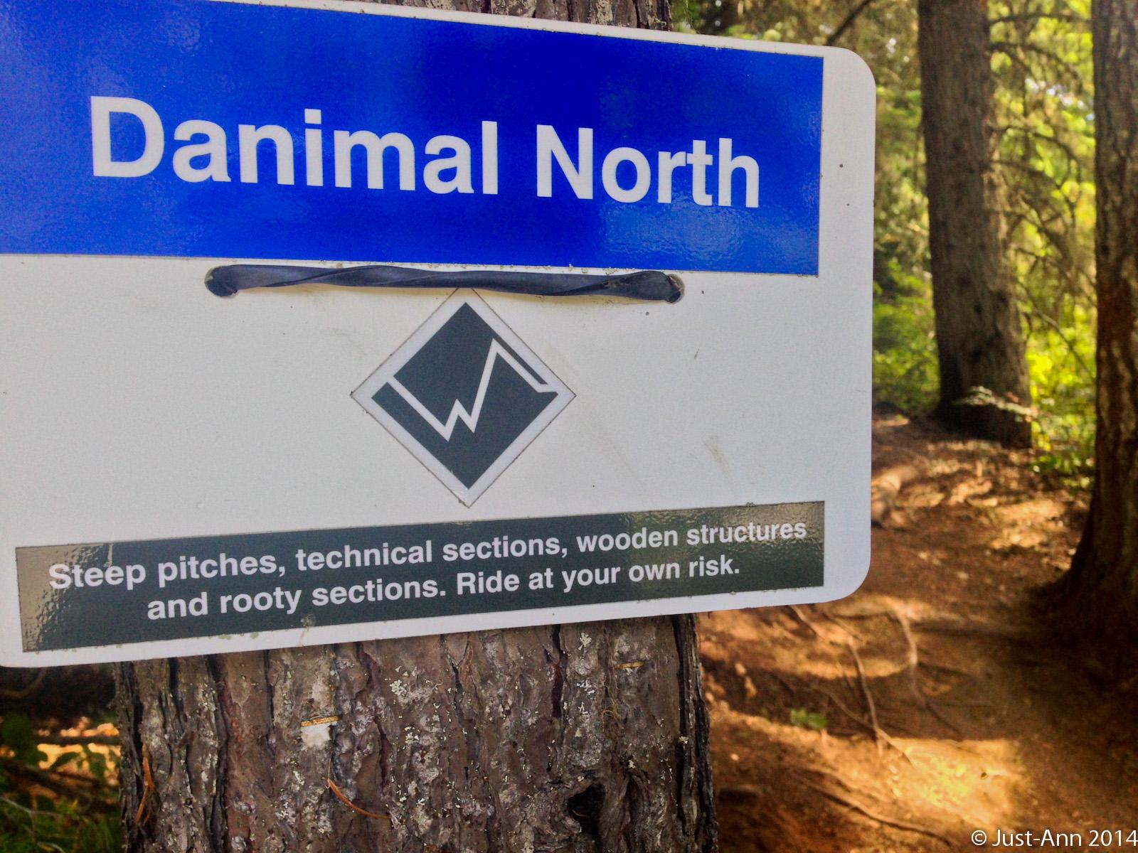A sign indicating the "Danimal North" trail, featuring a warning about the trail