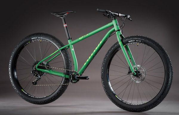Niner ROS 9 Plus: A green mountain bike with wide tires and a sturdy frame, positioned against a neutral background. The bike features a sleek design with a focus on durability and off-road capability.