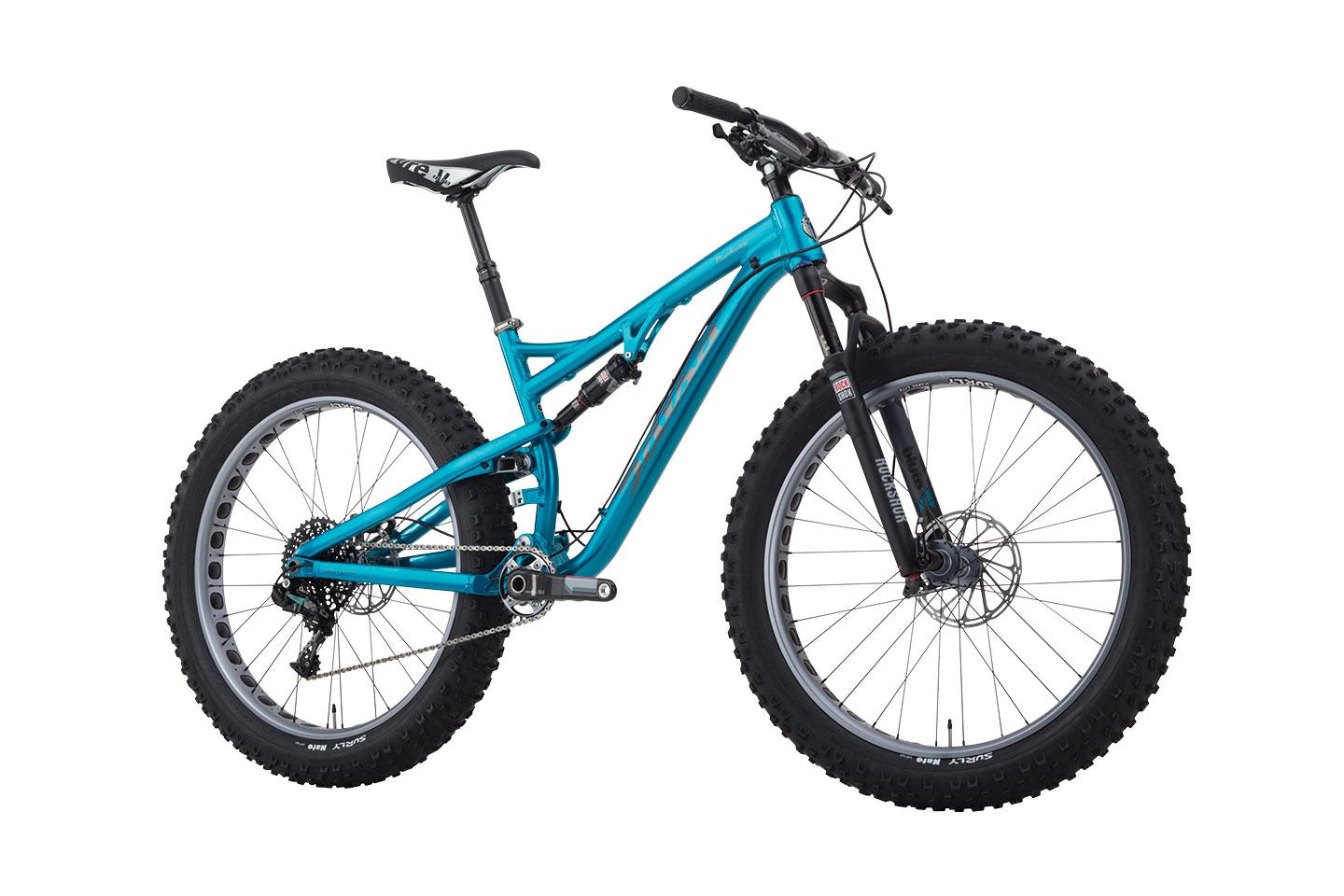 Salsa Bucksaw: A blue fat bike with wide tires, a suspension system, and a sleek, modern frame design. The bike is positioned on a white background, showcasing its components, including the handlebars, seat, and gears.