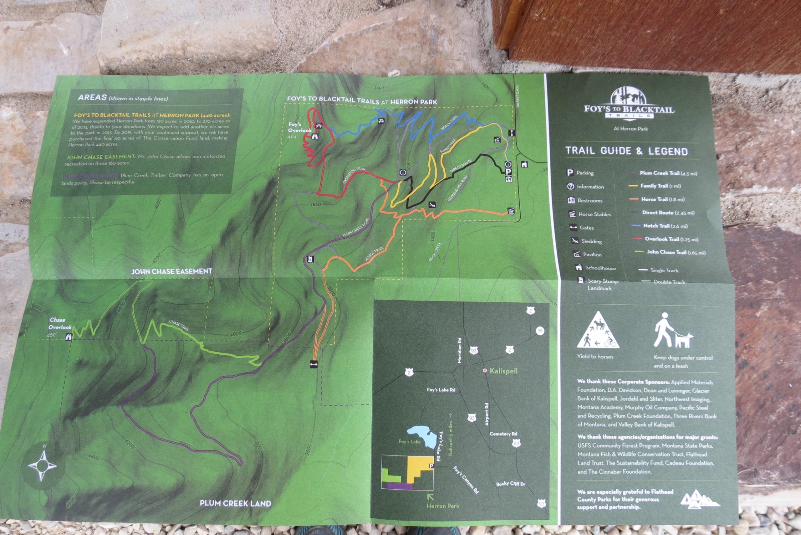 Map of Foy's to Blacktail Trails at Herron Park, featuring various trails, parking areas, and points of interest. The map includes a legend with trail lengths, types (single and double track), and nearby landmarks. There are marked areas such as parking, restrooms, and stables, along with notes regarding land use policies. Herron Park/foys To Blacktail Trail mountain bike trail.