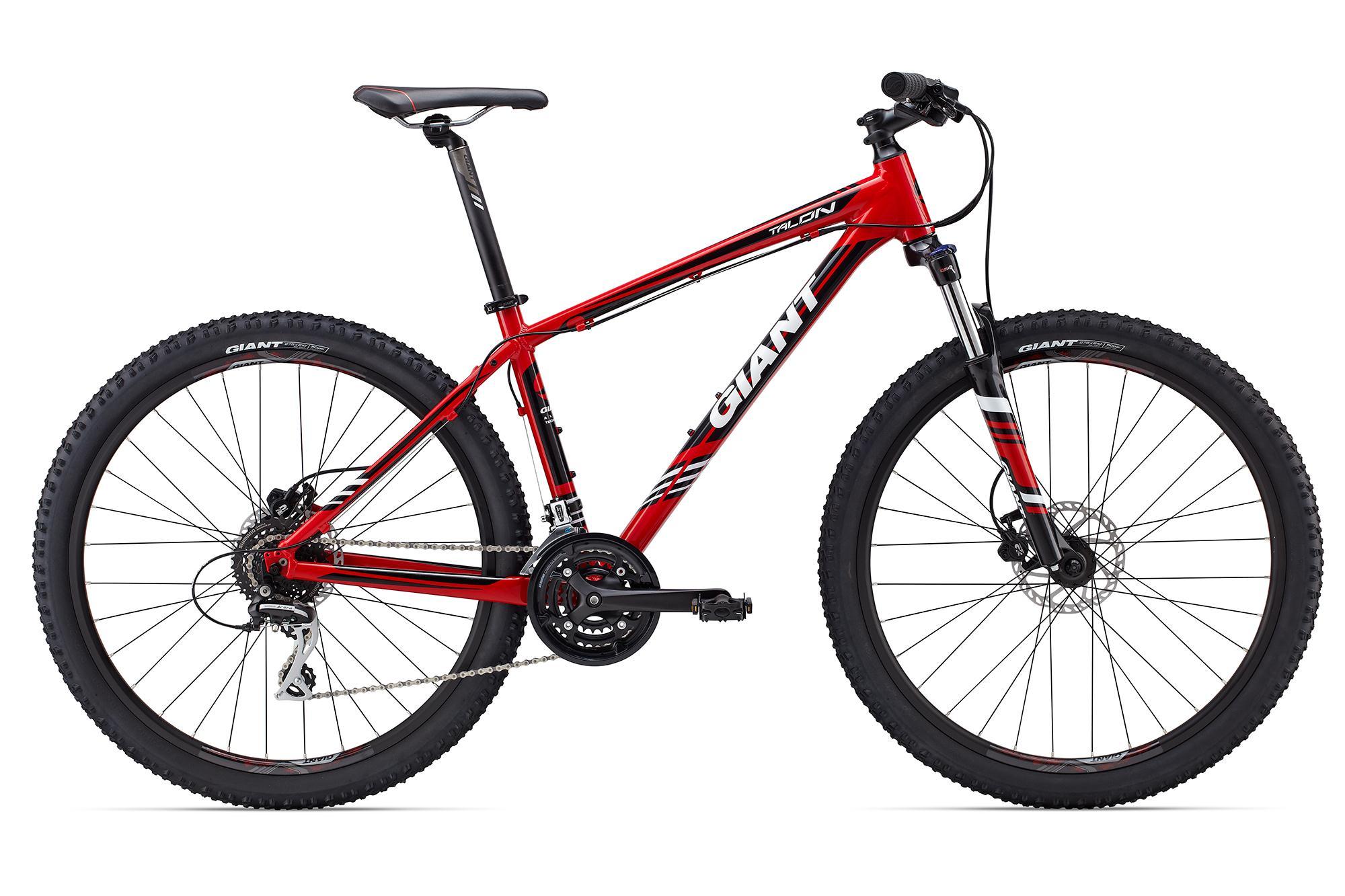 Giant Talon 27.5: Alt text: A red mountain bike with black and white accents, featuring a sturdy frame, wide tires with knobby tread, and disc brakes. The bike is positioned at a slight angle to showcase its design and components.
