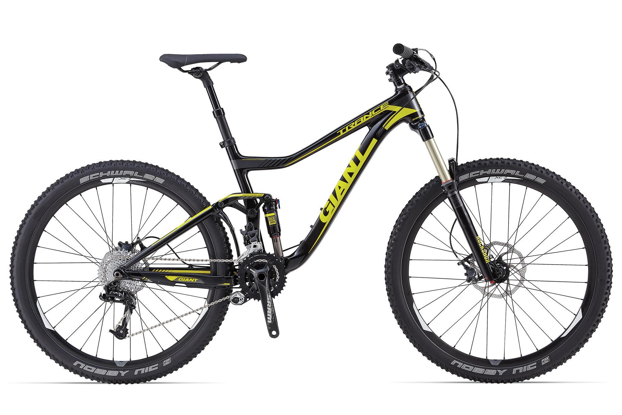 Giant Giant Trance Advanced 27.5 2: Alt text: A black and yellow mountain bike with large knobby tires, a suspension fork, and a sleek frame design, positioned against a white background. The bike features disc brakes and a variety of gears, highlighting its off-road capabilities.