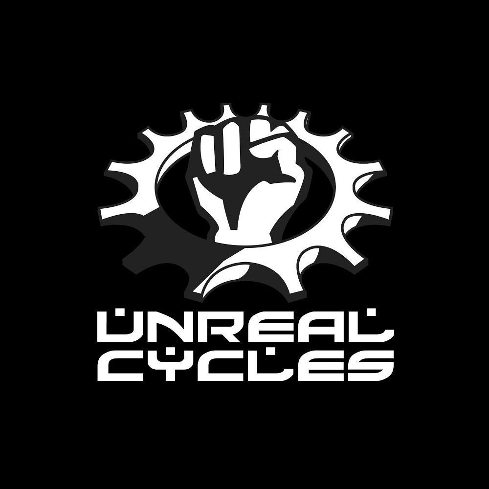 A black background features a stylized graphic of a raised fist inside a circular gear, symbolizing empowerment and cycling. Below the graphic, the words "UNREAL CYCLES" are displayed in bold, white typography.