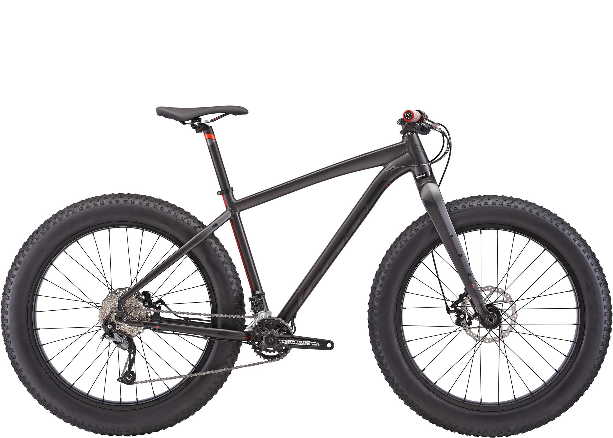 Felt Double Double: A black fat bike with wide tires, featuring a sleek frame and mountain bike components, positioned against a white background. The bike includes a saddle, handlebars with grips, and a visible drivetrain system.