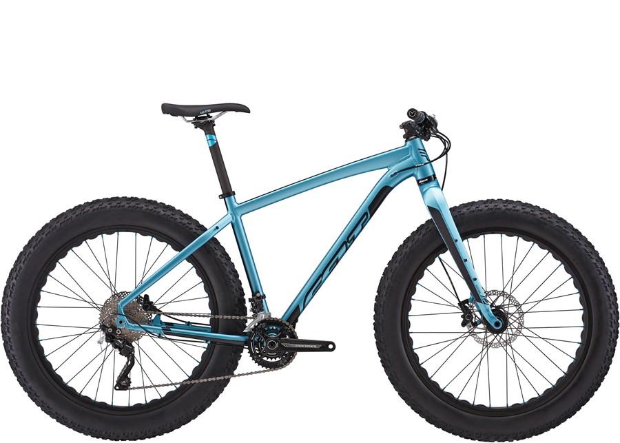 Felt Double Double: Alt text: A blue fat bike with wide tires, featuring a lightweight frame and a modern design. The bike is shown from the side, highlighting its components such as the gears and suspension.