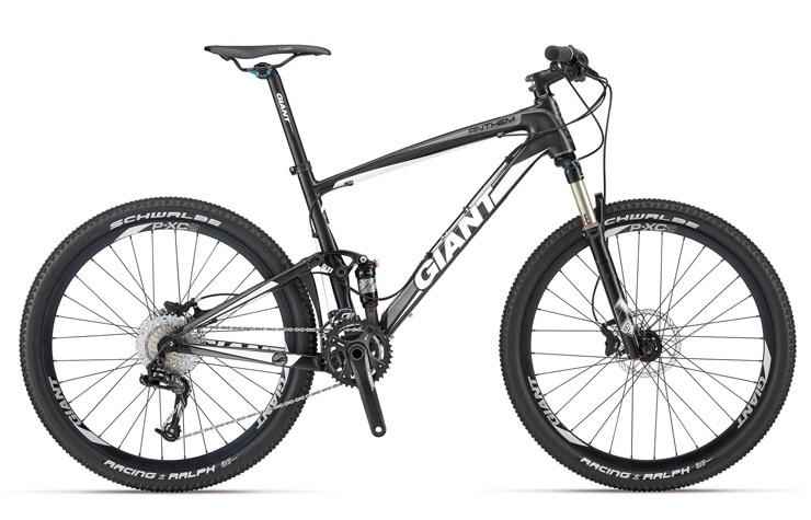 Giant Anthem Advanced: A black and silver mountain bike with the brand name "Giant" visible on the frame. It features wide tires, disc brakes, and a lightweight frame designed for off-road cycling. The bike is positioned upright against a neutral background.