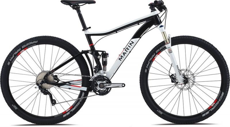 Marin Rift Zone 29er XC7: A modern mountain bike featuring a black and white frame, designed for performance and agility. The bike includes front suspension, a gear-shifting system, and knobby tires, suitable for off-road terrains. The brand name "Marin" is prominently displayed on the frame.