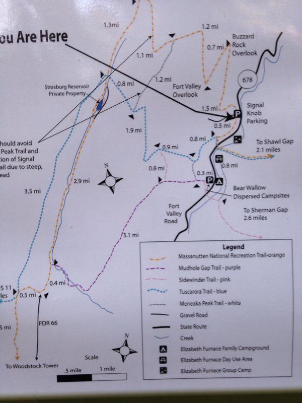 Map showing various trails and points of interest within the Massanutten National Recreation Area, including distances to landmarks such as overlooks and campsites. The map features a "You Are Here" indicator and a legend detailing trail colors and types, along with major roads and the surrounding area. Elizabeth Furnace mountain bike trail.