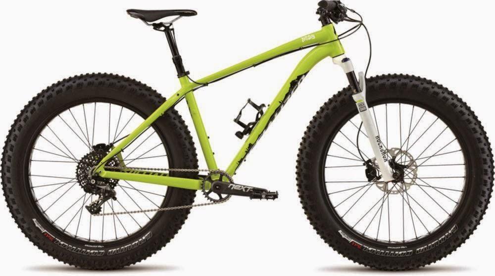 Specialized Fatboy Pro: A vibrant green fat bike with large, knobby tires, designed for off-road cycling. The bike features a lightweight frame, front suspension fork, and a single chainring drivetrain. The wheels are equipped with disc brakes for better stopping power in varied terrain.