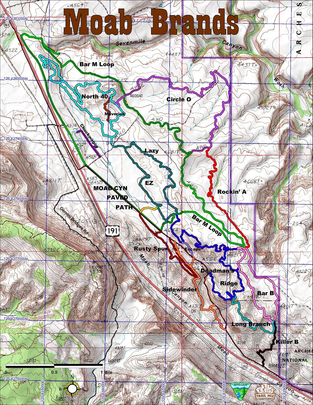 Map of the Moab Brands trail system, displaying various trails colored in blue, green, red, purple, and black. Topographic lines indicate elevation changes, with labeled trails such as Bar M Loop, North 40, Rockin' A, and Circle O. The map includes contour lines, a scale bar, and identifies nearby roads and features. Moab Brand Trails mountain bike trail.
