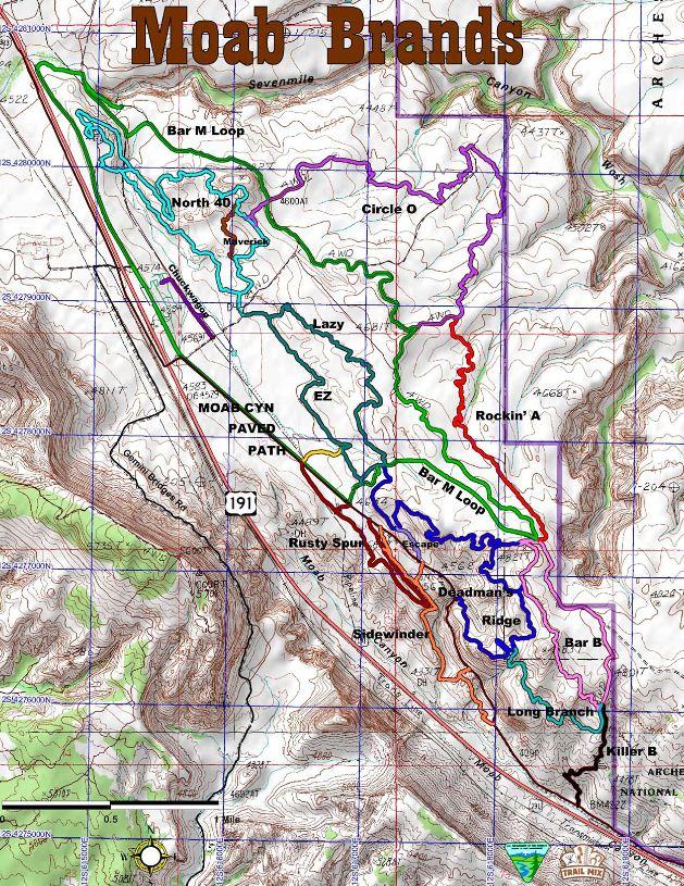 Map of Moab Brands trail system showing various marked trails in different colors. The map includes terrain details, trail names such as "Bar M Loop," "Circle O," and "Rockin' A," as well as nearby roads and elevation lines. The purpose is to guide users through the trail network for recreational activities like hiking and biking. Sidewinder mountain bike trail.