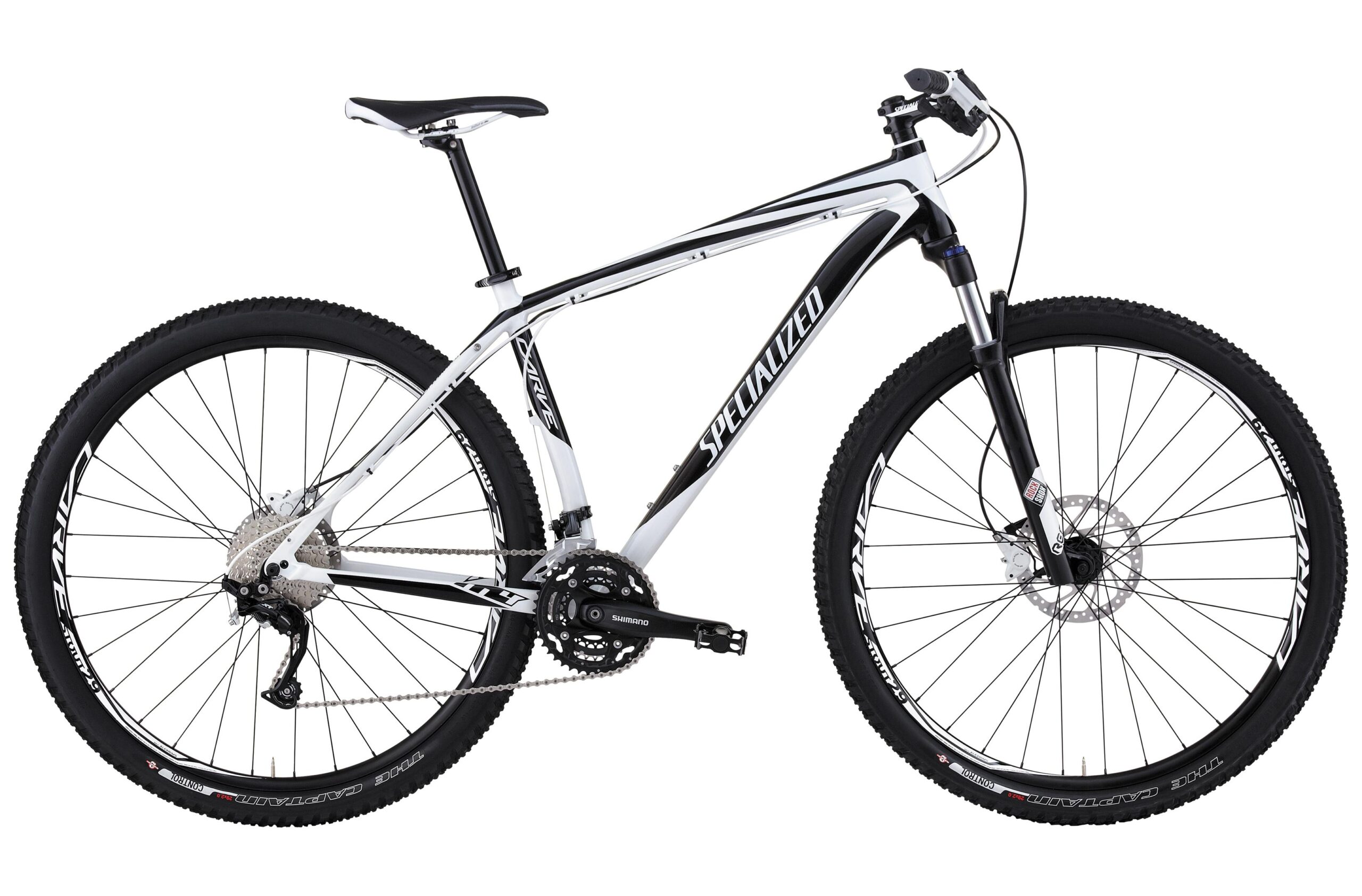 Specialized Carve Expert 29er: A white and black mountain bike featuring a lightweight frame, disc brakes, and wide tires designed for off-road riding. The bike has a Shimano gear system and a sleek, modern design.