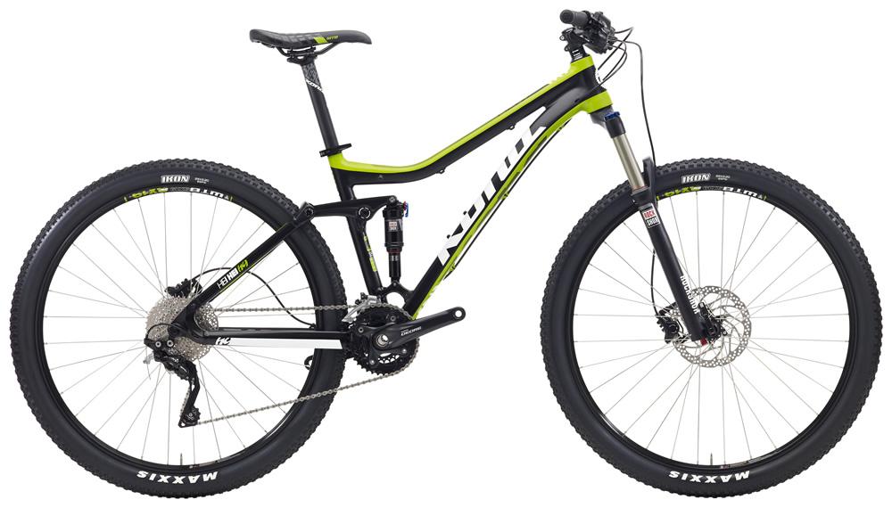 Kona Hei Hei: A black and green mountain bike with a lightweight frame, large wheels, and front suspension, displayed at an angle to showcase its design and components. The bike features a Shimano drivetrain and Maxxis tires, making it suitable for off-road cycling.