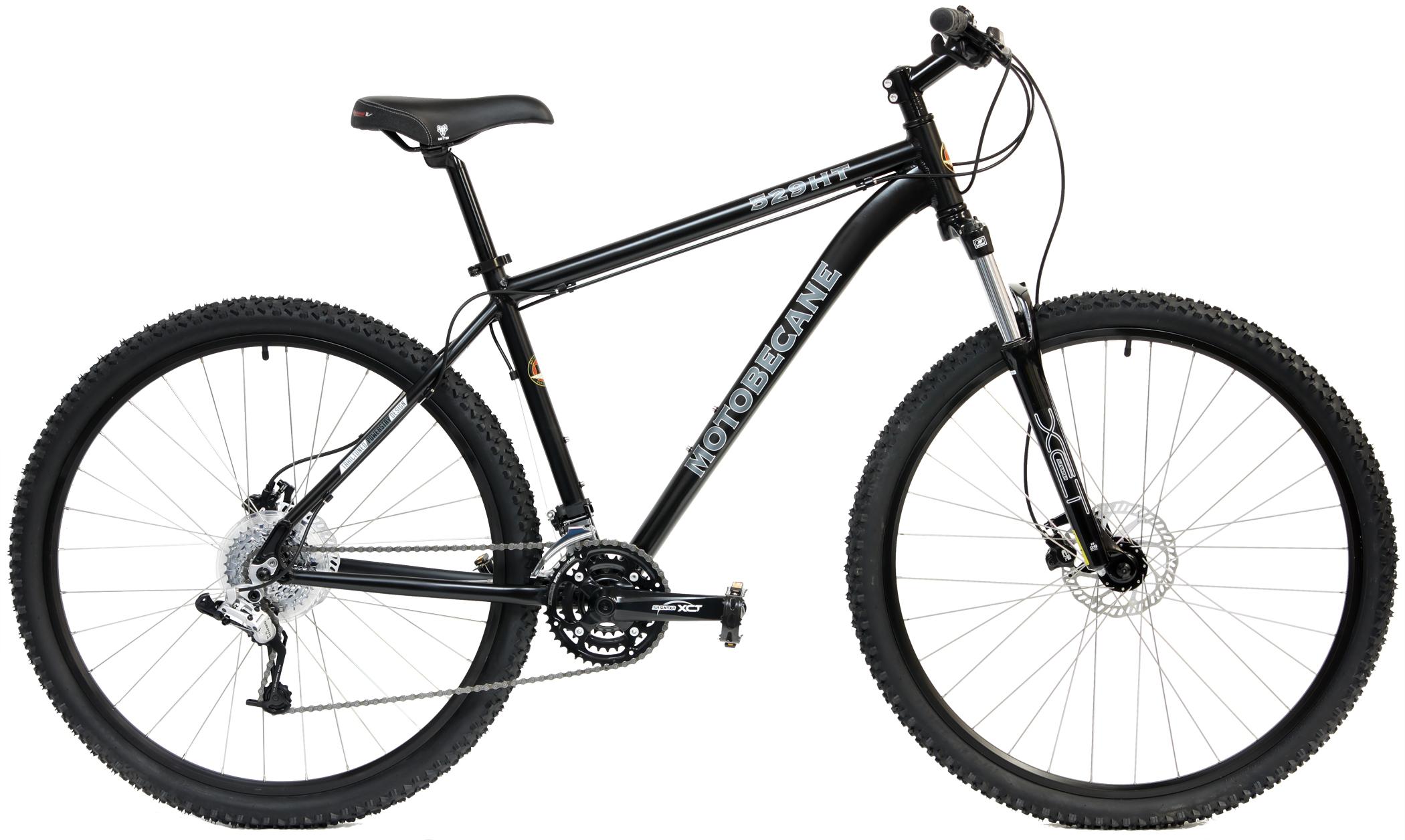 A black Motobecane mountain bike with front suspension and knobby tires, showcasing a sturdy frame and multiple gears. The bike is positioned against a white background, highlighting its features like the disc brakes and chain.