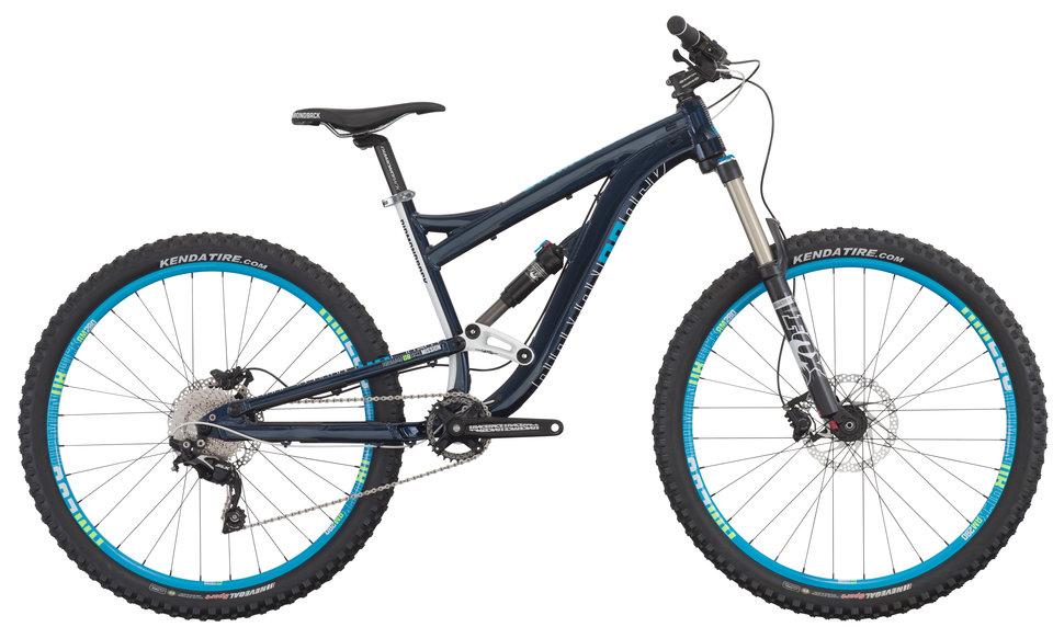 Diamondback Mission 1 27.5: A mountain bike with a blue frame, featuring wide tires and suspension components, positioned against a neutral background.