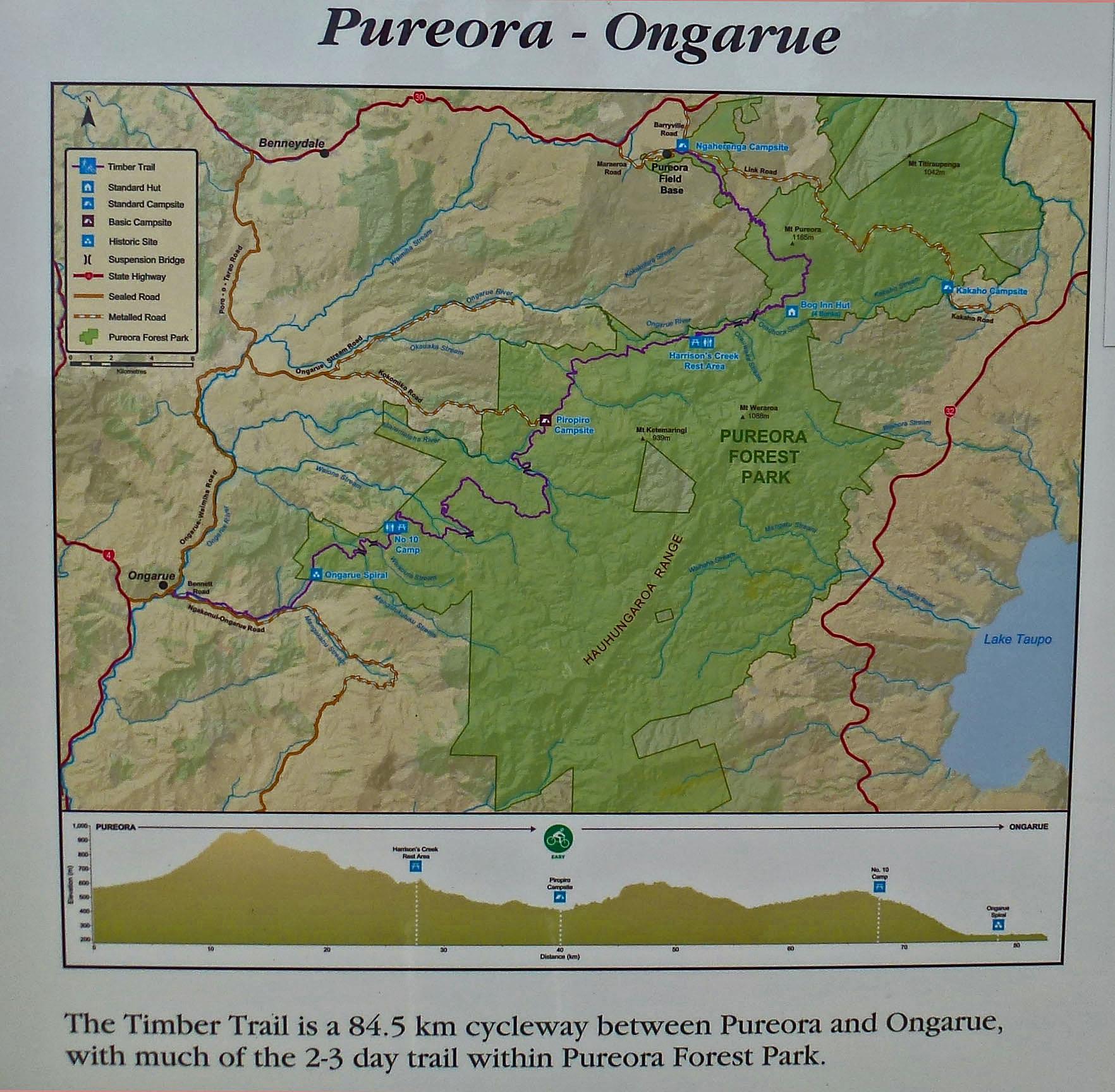 Map of the Timber Trail, a 84.5 km cycleway between Pureora and Ongarue, featuring highlighted routes, campsites, and park features within Pureora Forest Park. The map includes elevation profile and distances for key points along the trail. The Timber Trail mountain bike trail.