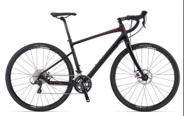 Giant Revolt 1: A sleek black gravel bike with red accents, featuring drop handlebars and disc brakes, displayed on a white background.