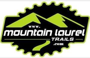 Logo for Mountain Laurel Trails featuring green mountains and a gear design, with the website URL "www.mountainlaureltrails.com" prominently displayed. Mountain Laurel Trails mountain bike trail.