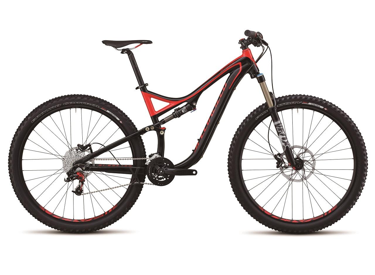 Specialized Stumpjumper: A black and red mountain bike with a sleek design, featuring wide tires, a suspension system, and a prominent gear mechanism. The bike is positioned upright against a neutral background, showcasing its frame and components clearly.