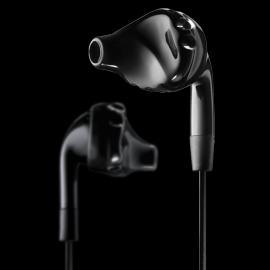 Yurbuds inspire - earbuds: Black in-ear headphones with a sleek design set against a dark background. One earbud is in sharp focus while the other is slightly blurred, showcasing their contoured shape.