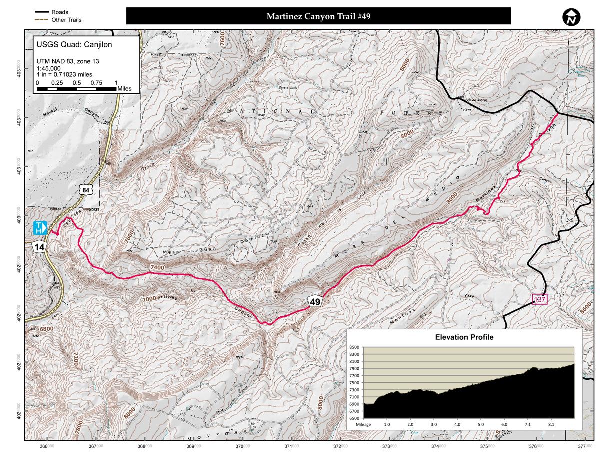 Map of Martinez Canyon Trail #49, showing the trail route in pink against a topographic background. Features include elevation contours, nearby roads, and other trails. The map also includes an elevation profile graph indicating changes in altitude along the trail. Martinez Canyon Trail #49 mountain bike trail.