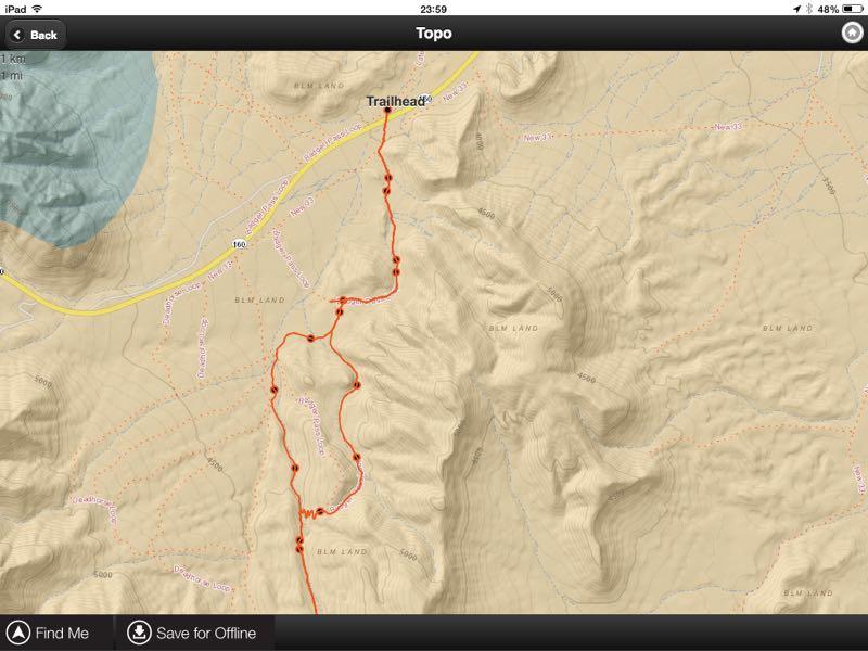 Topographic map showing a trailhead with a highlighted hiking route. The map features contour lines, elevation markings, and labels indicating land management areas, alongside a road and nearby body of water. Badger Pass Loop mountain bike trail.
