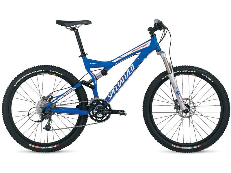 Specialized Stumpjumper FSR: Alt text: A blue mountain bike with a lightweight frame, wide tires, and front suspension, featuring the brand name "Specialized." The bike is positioned at a slight angle, showcasing its components and design.
