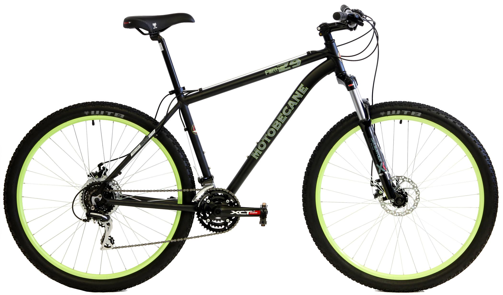Motobecane Fantom 29: A black Motobecane mountain bike with green accents, featuring large knobby tires, a sleek frame, and a disc brake system. The bike has a comfortable saddle and a gear system, designed for off-road and trail riding.