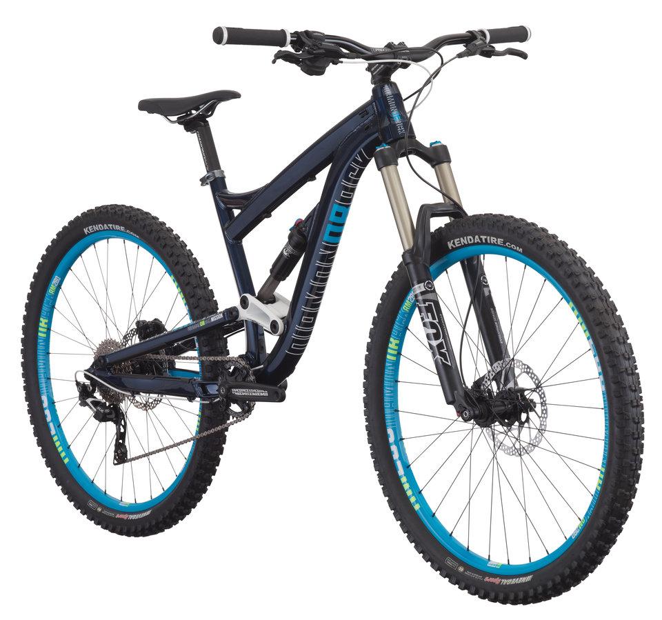 Diamondback Mission 1: A modern mountain bike featuring a durable frame in navy blue with turquoise accents. It has wide tires designed for off-road traction, front suspension forks, and a gear system visible near the rear wheel. The bike is positioned at an angle to showcase its components and design.