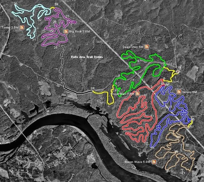 Map of the Fox's Area Trail System, displaying various marked bike trails in different colors, including their respective lengths in miles. The trails are interwoven through a topographical landscape, with notable trails like "Deep Step," "Skinny," and "Brown Wave" highlighted. A river runs along the bottom of the map, providing geographical context. Forks Area Trail System (FATS) mountain bike trail.