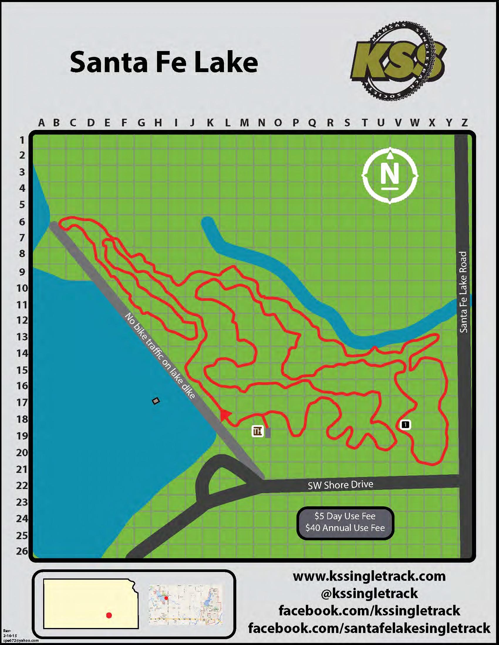 Map of Santa Fe Lake, featuring trail routes highlighted in red, surrounded by a green grid. Key information includes a scale for navigation, parking locations, and signage indicating no bike traffic on the lake dike. Contact details and fee information are provided at the bottom. Santa Fe Lake Trail mountain bike trail.