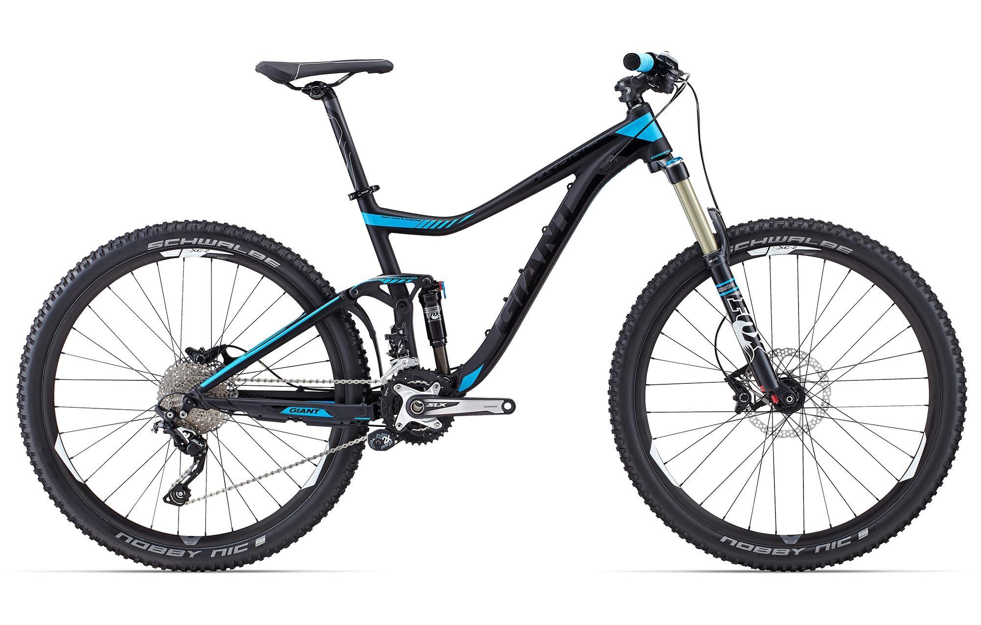 Giant Giant Trance 27.5 2: A black and blue mountain bike is displayed against a white background, featuring prominent elements like wide tires, front suspension fork, and a sleek frame design. The bike is equipped with Schwalbe tires and a Shimano drivetrain, showcasing a modern design suitable for off-road cycling.