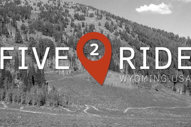 Image featuring a mountainous landscape in black and white with the text "FIVE 2 RIDE" and a location pin icon in orange, indicating Wyoming, USA.