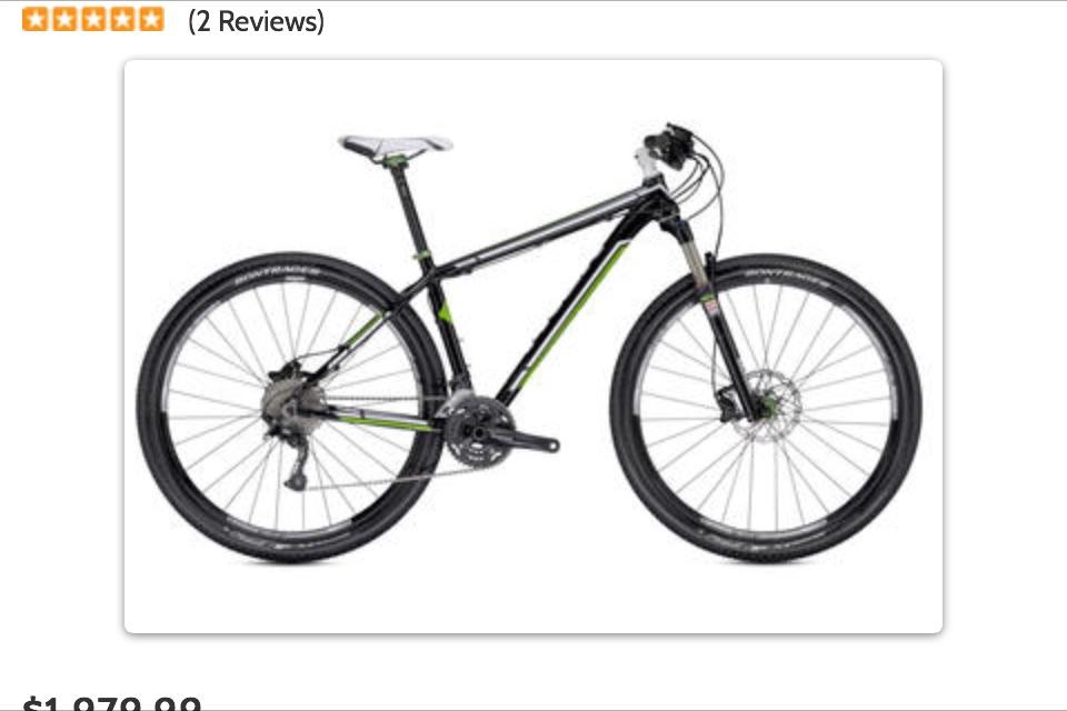 Trek Superfly AL: Alt text: "Black and green mountain bike with slick tires and a lightweight frame, featuring disc brakes and a modern design."